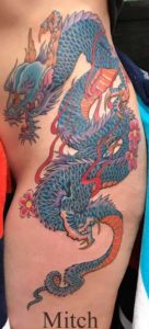 Traditional Japanese tattoo on woman's hip with cherry blossoms