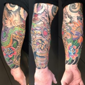 three pictures of a Japanese style tattoo sleeve of a tibetan skull with a colorful snake and flowers.